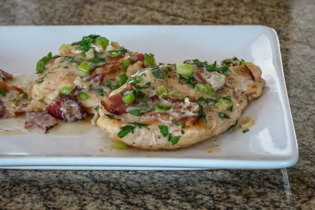 chicken with bacon and sour cream sauce on a serving plate