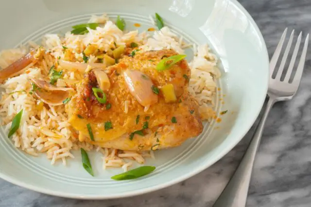 chicken thighs and harissa sauce over rice