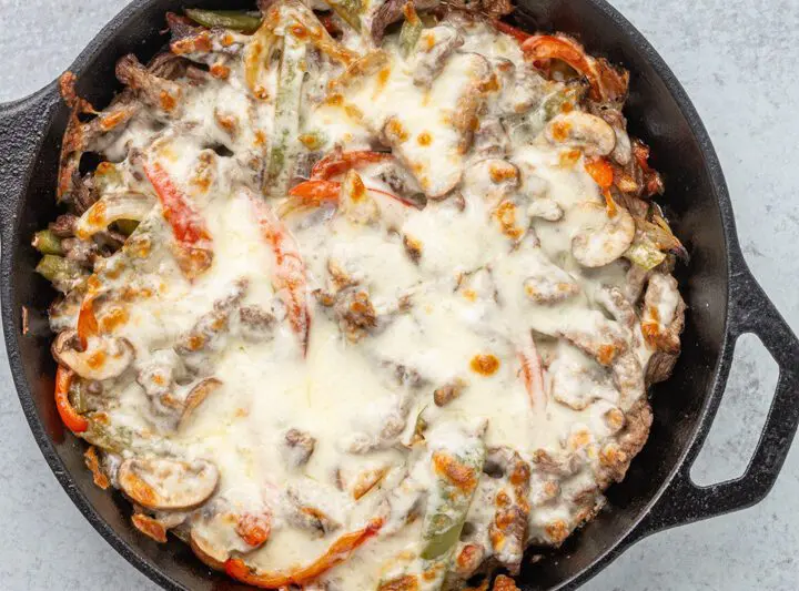 philly cheesesteak skillet in an iron skillet with cheese