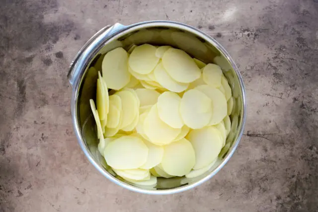 Dauphinoise potato gratin prep—sliced yellow potatoes.