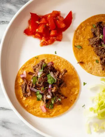 slow cooker barbacoa shredded on tortillas