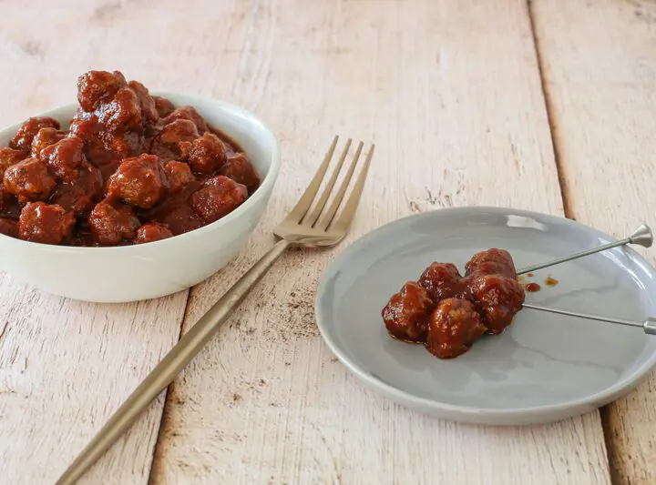 slow cooker barbecue meatballs appetizer in a bowl with a few on a plate