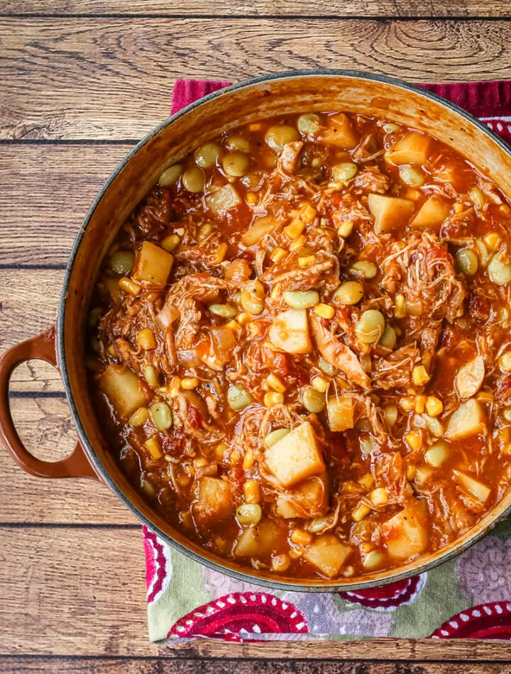 A bowl of rich and delicious Brunswick stew with corn muffins on the side.