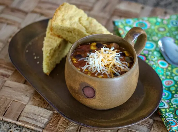 slow cooker chicken enchilada soup and cornbread on a serving tray