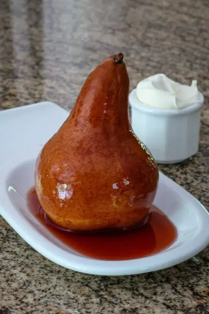 slow cooker wine poached pear on a serving dish