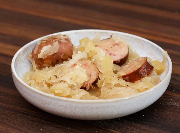 smoked sausages, sauerkraut, and apple meal in a bowl, cooked in the slow cooker