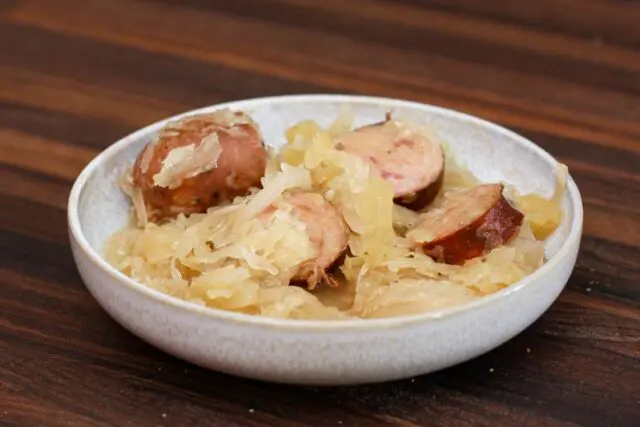 smoked sausages, sauerkraut, and apple meal in a bowl, cooked in the slow cooker