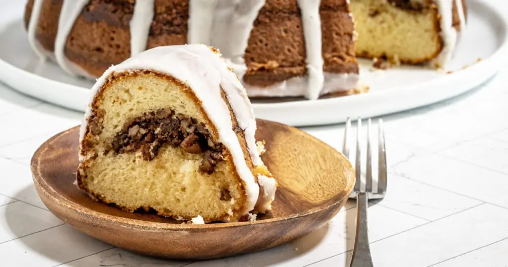 slice of sock it to me cake with the whole cake in the background