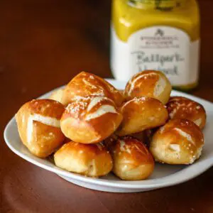 soft pretzel bites with a jar of mustard in the background