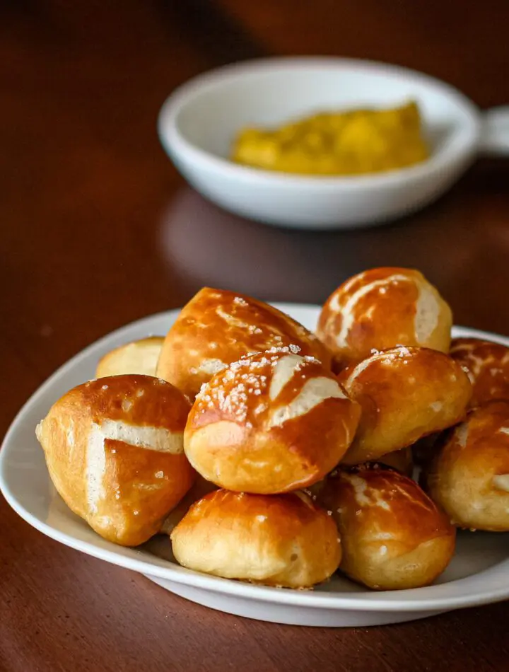 soft pretzel bites with mustard for dipping in the background