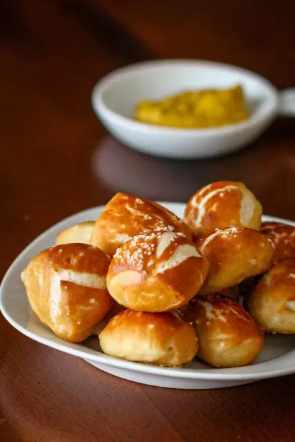 soft pretzel bites with mustard for dipping in the background