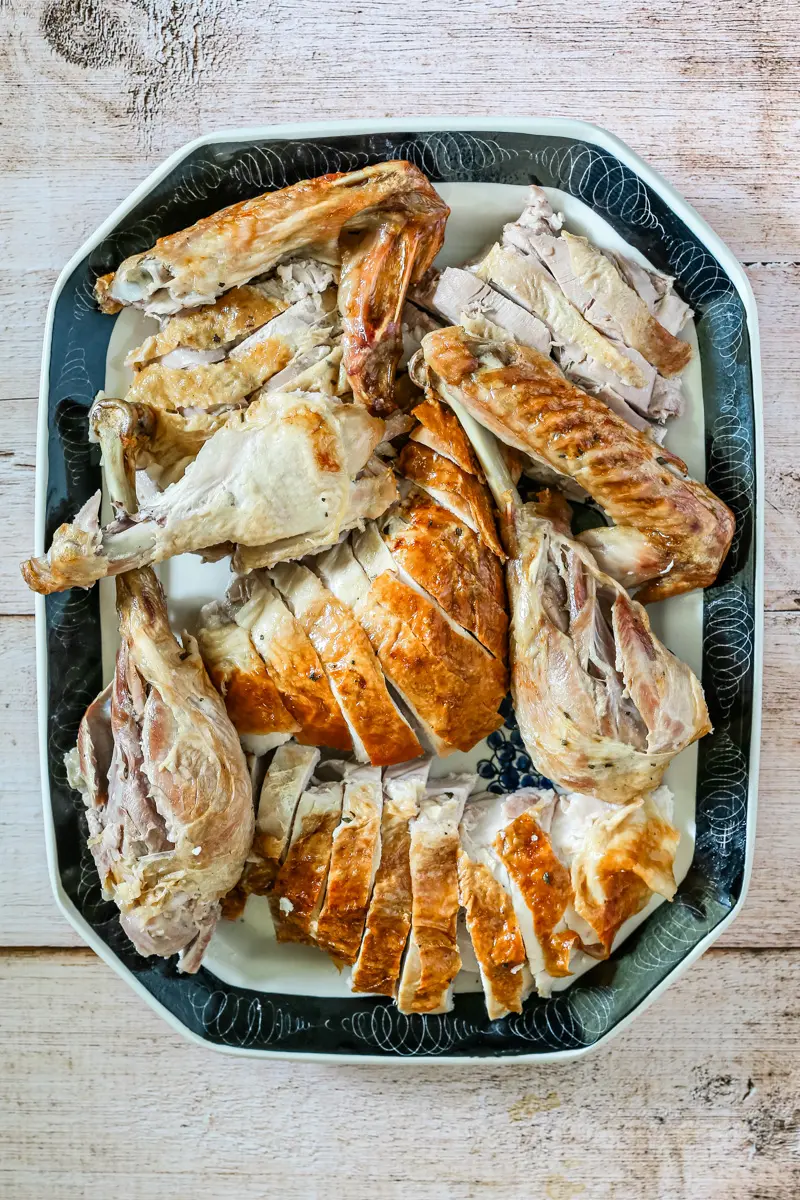 A carved spatchcocked turkey on a large platter.