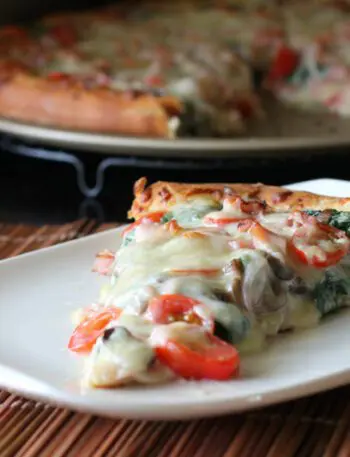 ham and spinach pizza on a plate