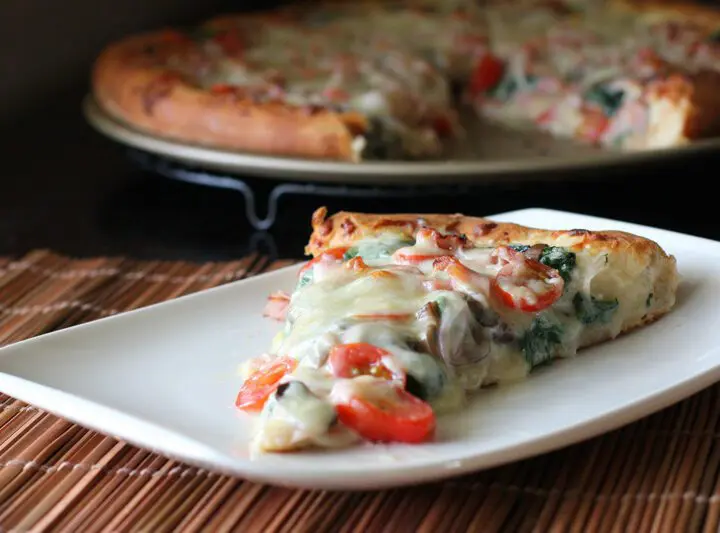 ham and spinach pizza on a plate