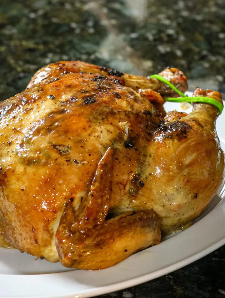 a sriracha glazed roast chicken on a platter