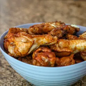 a bowl with sriracha chicken wings