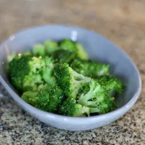 A small dish with fresh steamed broccoli