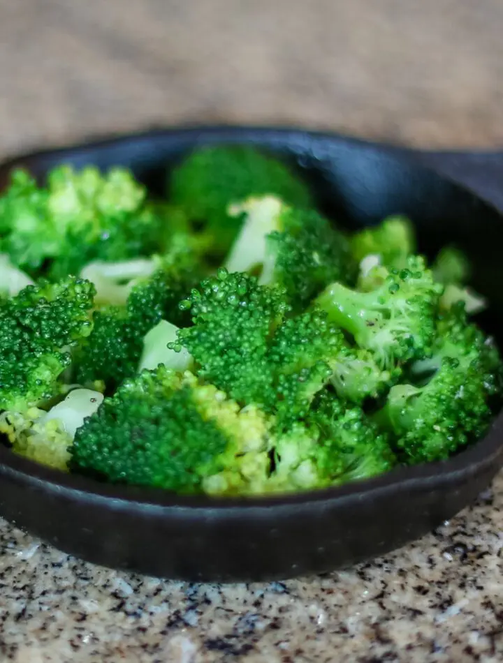 steamed broccoli in a small cast iron serving pan