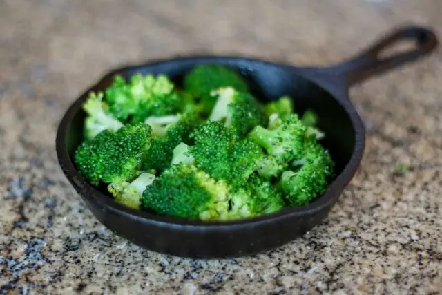 steamed broccoli in a small cast iron serving pan