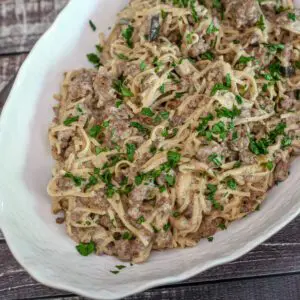 beef stroganoff and noodles in a large serving bowl