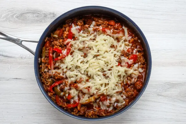 stuffed pepper casserole, baked, with fontina cheese melting on top of it.