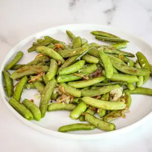 roasted sugar snap peas on a platter