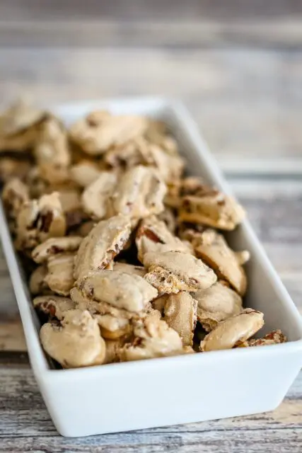 sugared pecans snack in a small decorative dish