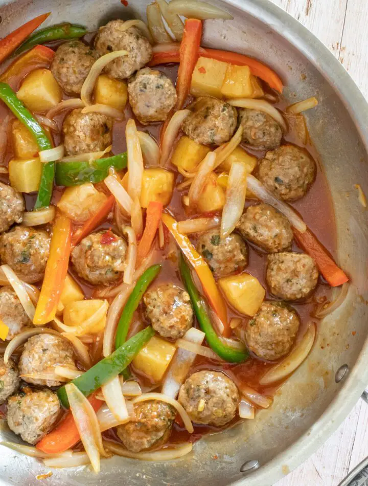 sweet and sour pork meatballs with stir-fried vegetable in the pan