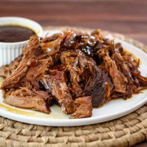 Tender sweet and sour pot roast, shredded, on a platter