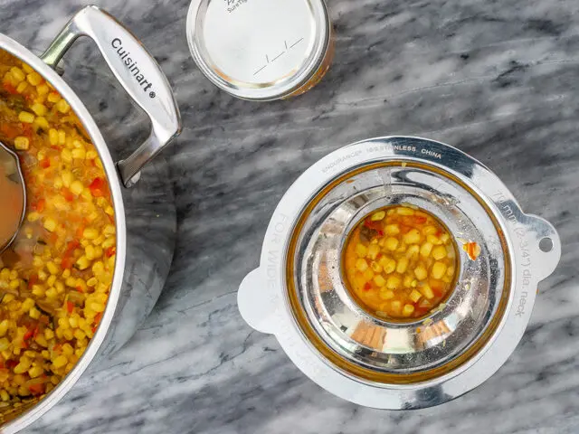 Filling jars with homemade corn relish