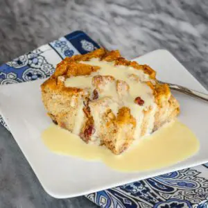 A slice of sweet potato bread pudding with vanilla sauce