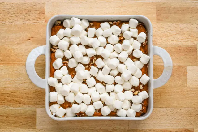 Sweet potato casserole for two prep: marshmallows are added to the partially baked casserole.