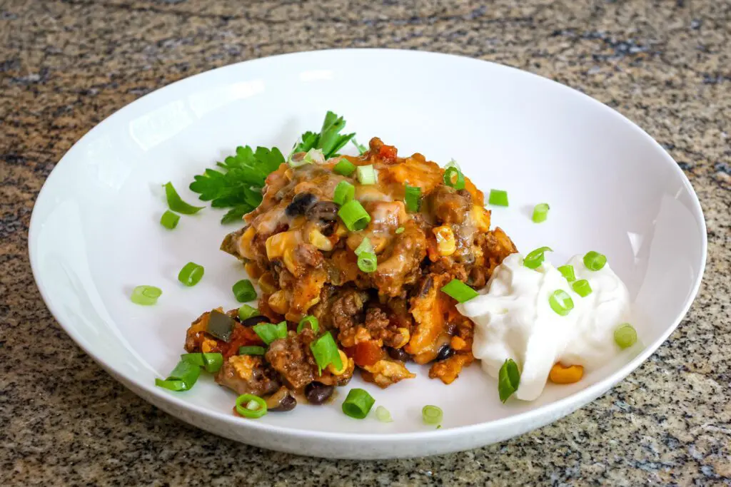 ground beef ranch casserole on a plate with sour cream