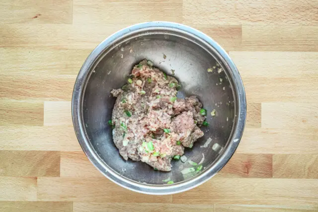 Combined ground pork, green onions, garlic, panko, and egg for teriyaki meatballs.