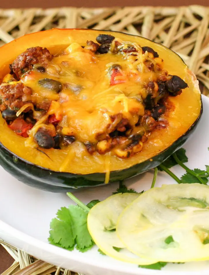 tex mex stuffed acorn squash with ground beef and black beans on a plate