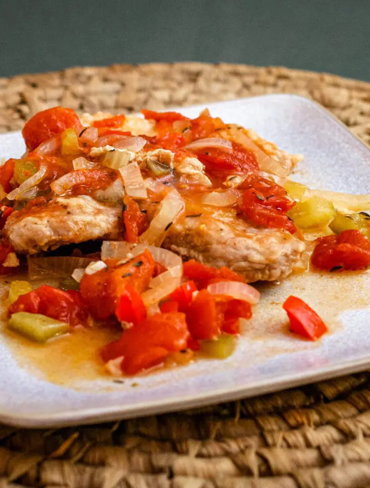 creole style pork chops with tomatoes on a plate