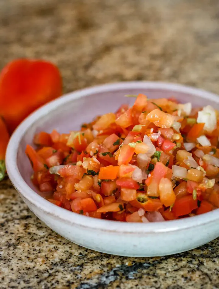 a small bowl of tomato salsa with chile peppers