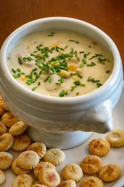 tuna chowder in a bowl with chives for garnish