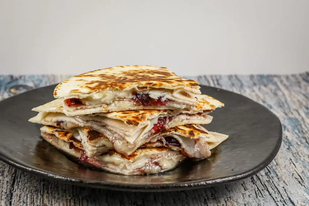 stack of quesadillas with turkey, brie cheese, and cranberry sauce