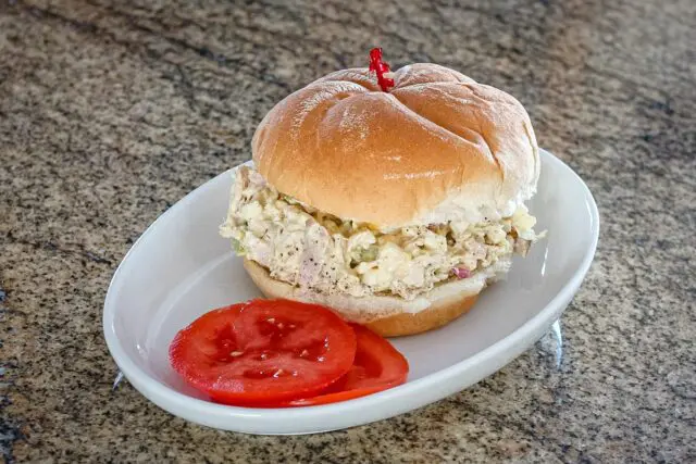 turkey and egg salad sandwich on a soft bun