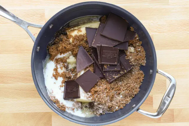 Preparing the batter for the ultimate fudgy brownies: melting the butter and chocolate with sugars.