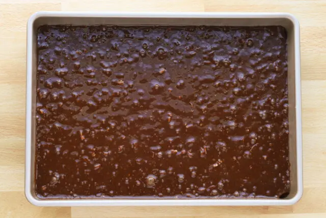 Brownie batter spread in the baking pan, ready to bake.