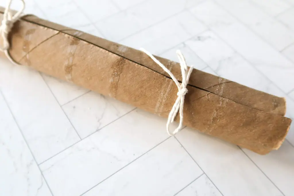 An empty cardboard paper towel cylinder helps keep the cookie dough log round while they chill.