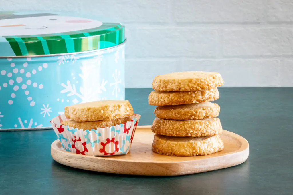 vanilla sable cookies shown with a Christmas tin