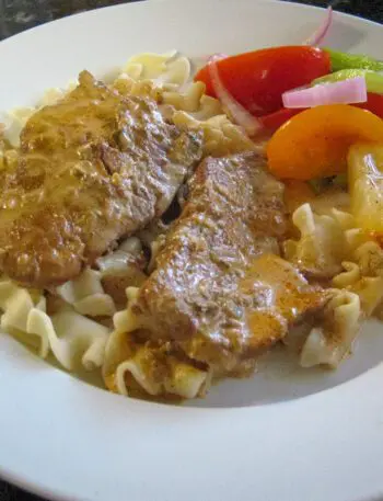 plate of veal steaks on noodles