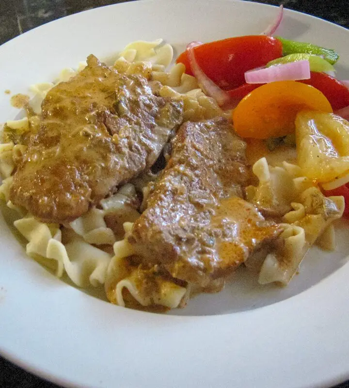 plate of veal steaks on noodles