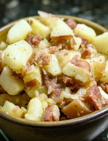 warm potato salad with sausage in a bowl