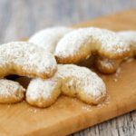 almond crescent cookies on a board