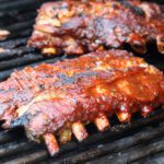 ribs on the grill with maple apple barbecue sauce