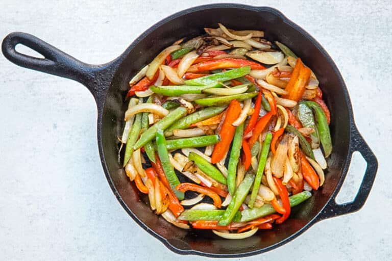 Peppers and onions in the skillet for a Philly cheesesteak skillet.